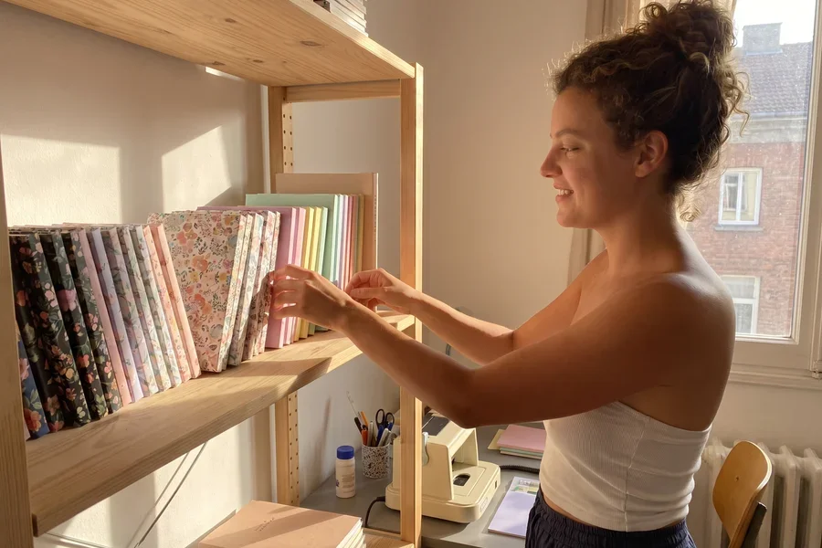 Cutting and binding her first notebook
