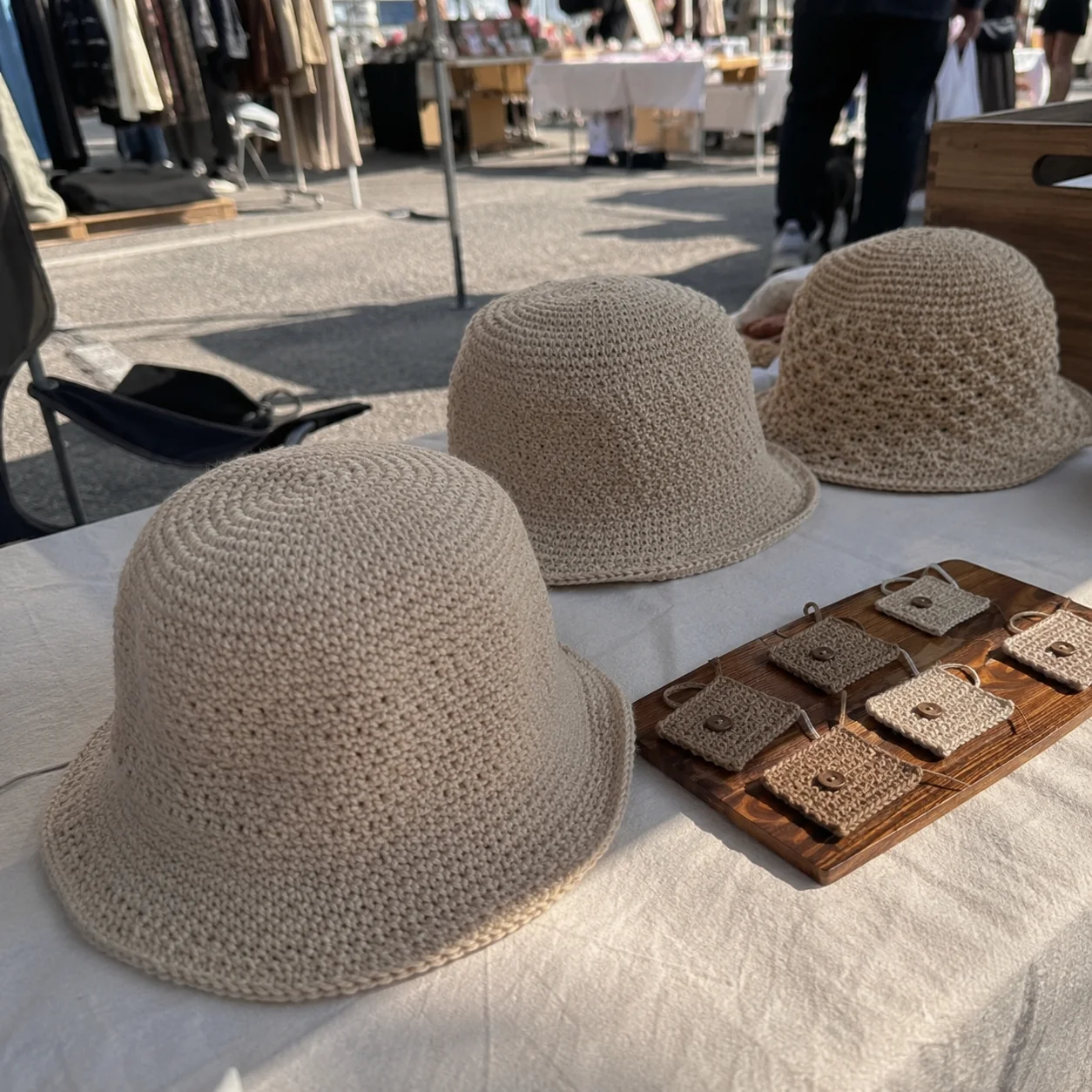 Crochet hats at a craft fair table